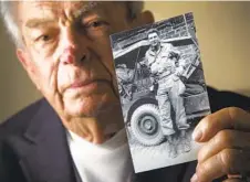  ?? HOWARD LIPIN U-T FILE ?? Jack Port holds a photo of himself as a 22-year-old Army soldier serving in Europe during World War II. Port died last month at age 98.