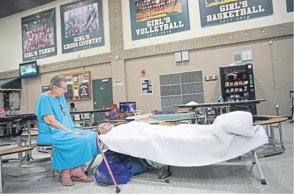  ?? Picture: Getty Images. ?? Brenda and Ronald Whitmer wait in an evacuation shelter set up at a high school in Conway, South Carolina, as the state awaits the arrival of Hurricane Florence.