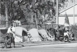  ?? RICARDO RAMIREZ BUXEDA Orlando Sentinel/TNS | Feb. 6, 2023 ?? A camping-ban law in Florida, developed through the work of a Texas-based think tank, will force cities to break up settlement­s such as this one in Orlando.