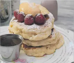  ?? Photos: David Harrison ?? Delicious: Thick buttermilk flapjacks with banana, raspberrie­s, salted caramel butter and warm maple butter.