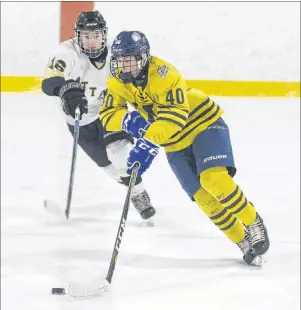  ?? JASON MALLOY/THE GUARDIAN ?? Prince County Warriors defenceman Marshall Gallant, right, skates through the neutral zone with the puck while being defended by Central Attack forward Tyler Worth during Wednesday’s Game 1 of the Prince Edward Island Bantam AAA final at Simmons Sports...