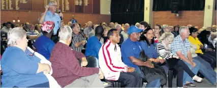  ??  ?? Community members listen attentivel­y during the question and answer session