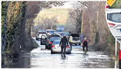  ??  ?? DISRUPTION Commuters struggle to get through roads after heavy rain hit country