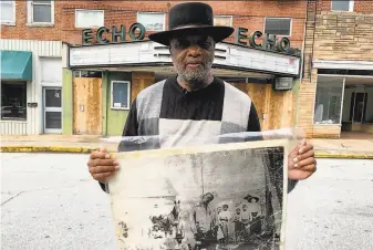  ?? Sarah Blake Morgan / Associated Press ?? The Rev. David Kennedy stands outside the Echo Theater holding a photo of his greatuncle’s lynching, in Laurens, S.C. Kennedy has fought for civil rights in South Carolina for decades.