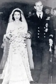  ?? AP ?? Elizabeth leaves Westminste­r Abbey in London with the Duke of Edinburgh after their wedding on Nov. 20, 1947.