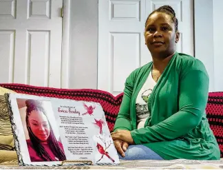  ?? NICK GRAHAM/STAFF ?? Stefanie Easley sits with a picture of her sister, Erica Easley, who was killed in a car crash caused by a distracted driver. Stefanie started the Erica Easley Foundation to teach people about the dangers of distracted driving.