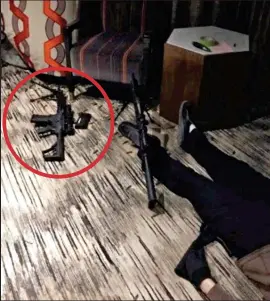  ??  ?? Arsenal: Images of Paddock’s hotel room revealed two semiautoma­tic weapons – one left near what appears to be the killer’s dead body. Left inset: One rifle with a high-powered scope can be seen on a tripod through the breached doorway