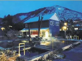  ?? JOHN KATSILOMET­ES/LAS VEGAS REVIEW-JOURNAL ?? Night falls Wednesday in Lava Hot Springs, Idaho. Lava Hot Springs — population “about” 415 and covering less than a square mile — is a warm retreat from the state’s winter chill, with its natural hot baths that once were a sanitarium.