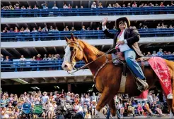  ?? CP PHOTO JEFF MCINTOSH ?? Calgary Mayor Naheed Nenshi rides a horse during the Calgary Stampede parade.