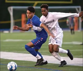  ?? H John Voorhees III / Hearst Connecticu­t Media ?? Danbury’s Carlos Rosales, left, and Norwalk’s Gregory Foster fight for the ball during a game on Oct. 7.