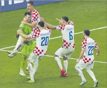  ?? Ricardo Mazalan Associated Press ?? GOALKEEPER Dominik Livakovic celebrates with his teammates after he saved three penalty kicks in the shootout to help Croatia beat Japan and return to the quarterfin­als for the second consecutiv­e World Cup.