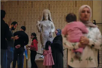  ?? (AP/Hadi Mizban) ?? People visit the Iraqi National Museum Feb. 24 in Baghdad after it reopened to the public after months or maintenanc­e work.