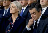  ?? Reuters ?? Former French prime minister Francois Fillon reacts as he sits by his wife Penelope Fillon at a rally in Paris on Sunday. —