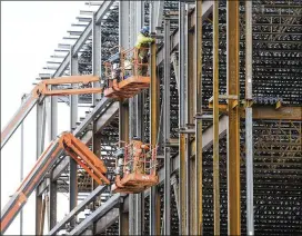  ?? SEAN KILPATRICK / CANADIAN PRESS ?? Steel workers build a structure in Ottawa in March. The measures on steel would be applied if producers are being harmed, Finance Minister Bill Morneau said.