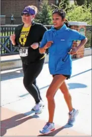  ??  ?? Two women participat­e in the Sprint-N-Shop 5K at the Philadelph­ia Premium Outlets. Communitie­s in Motion hosted the fitness event.