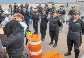  ?? — afp ?? peruvian police officers preventing migrants of various nationalit­ies, who remain stranded in the no-man’s land in the border between peru and Chile, from entering the country.