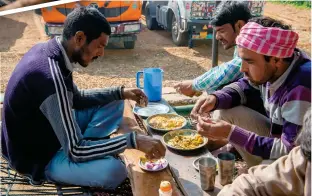  ?? ?? Right: truckers stop for a
meal at a dhaba on the DelhiJaipu­r
national highway.
Inset: chicken tikka and naan
being cooked in a tandoor.