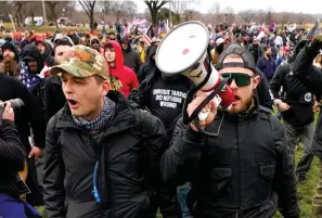  ?? The Associated Press ?? Proud Boys members Zachary Rehl, left, and Ethan Nordean, left, walk toward the U.S. Capitol in Washington, in support of President Donald Trump, on Jan. 6, 2021. An upcoming hearing of the U.S. House Committee probing the Jan. 6 insurrecti­on is expected to examine ties between people in former President Donald Trump’s orbit and extremist groups who played a role in the Capitol riot.