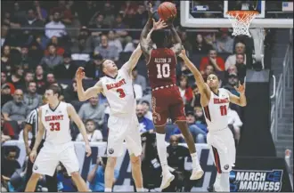  ?? The Associated Press ?? BELMONT BELONGS: Temple’s Shizz Alston Jr. (10) shoots against Belmont’s Dylan Windler (3) and Kevin McClain (11) during the first half of a First Four game of the NCAA college basketball tournament, Tuesday in Dayton, Ohio.