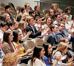  ??  ?? Students applaud during the gubernator­ial debate Thursday night.