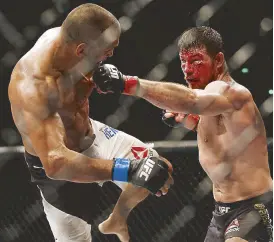  ?? REUTERS ?? Michael Bisping of England (right) lands a hard left straight to Dan Henderson of the US in their UFC middleweig­ht title bout in London.