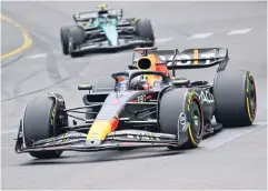  ?? AFP ?? Red Bull’s Max Verstappen, front, and Aston Martin’s Fernando Alonso in action at the Monaco Grand Prix.