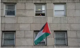  ?? ?? A Palestinia­n flags waves as Columbia University students protest in New York against the suspension of two pro-Palestinia­n groups. Photograph: Derek French/SOPA Images/Shuttersto­ck