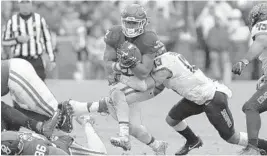  ?? ALONZO ADAMS/AP ?? Oklahoma running back Samaje Perine rambled for 239 yards on a career-high 37 carries. Here, he runs through a tackle attempt by Oklahoma State safety Jordan Sterns.