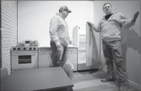  ?? File Photo/DAVID GOTTSCHALK ?? John Burroughs (right), director of the Rogers Historical Museum, talks with Robert Rousey (left), curator of education, in the child-size kitchen inside the renovated Hailey Building at the Rogers Historical Museum in downtown Rogers.