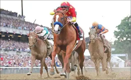  ?? ROB CARR/GETTY IMAGES/AFP ?? Justify, ridden by jockey Mike Smith crosses the finish line to win the 150th running of the Belmont Stakes at Belmont Park on Saturday in Elmont, New York.