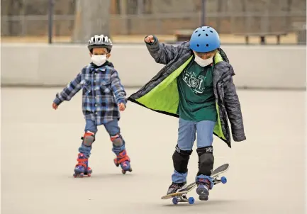  ?? LUIS SÁNCHEZ SATURNO/THE NEW MEXICAN ?? Seven-year-old Jonathan Romero, left, and his brother Josiah Romero, 9, of Santa Fe skate at Herb Martinez Park on Monday while the weather was still clear. The National Weather Service has forecast up to 2 inches of snow in Santa Fe on Monday, with a good chance of rain and lesser chance of snow starting Thursday night through Saturday.