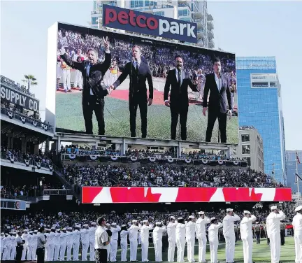  ?? GREGORY BULL/THE ASSOCIATED PRESS FILES ?? The Tenors, seen on the scoreboard, sing the Canadian national anthem prior to the MLB all-star game.