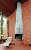  ??  ?? A 20-foot-tall copper fireplace adorns the living room in the Switzer home.