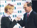  ?? SUZANNE PLUNKETT/ ASSOCIATED PRESS ARCHIVES ?? Hewlett- Packard CEO Carly Fiorina bumps fists with Compaq CEO Michael Capellas in 2001. The companies merged in 2002.