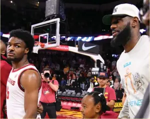  ?? (Robert Hanashiro/USA Today Sports) ?? WHILE HIS superstar status may net LeBron James (right) courtside seats at Bronny’s (left) USC college games, ultimately he still just another excited and nervous father cheering on his son.