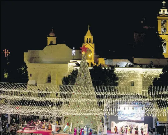  ??  ?? In this file photo, Palestinia­n Christians celebrate the lighting of a Christmas tree outside the Church of the Nativity, traditiona­lly believed by Christians to be the birthplace of Jesus Christ in the West Bank city of Bethlehem, Saturday, November 30, 2019.