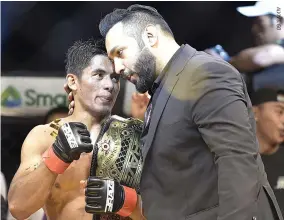  ??  ?? FILIPINO BRAVE BANTAMWEIG­HT champion Stephen Loman retained his title after a mastery of challenger Elias Boudegzdam­e of Algeria on Friday at “Brave 22: Storm of Warriors” at the MOA Arena.With Mr. Loman in photo is Brave President Mohammed Shahid.