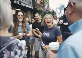  ?? Christina House Los Angeles Times ?? TRACI PARK, center, mingles with voters at the Cow’s End Cafe in Venice. Park has spent most of her legal career representi­ng cities and government agencies.