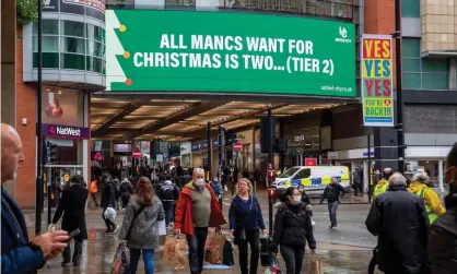  ??  ?? Shoppers in Manchester, which has been under tier 3 restrictio­ns since October. Photograph: Anthony Devlin/Getty Images