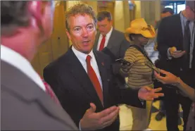  ?? Cliff Owen / AP ?? Sen. Rand Paul, R-Ky., talks with reporters Sunday after his address to the Senate in Washington. Over the weekend Paul blocked an attempt by fellow Kentucky Republican Mitch McConnell, the Senate majority leader, to reauthoriz­e the USA Patriot Act. In...