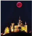  ?? MATTHIAS HANGST / GETTY IMAGES ?? A blood moon rises behind The Hohenzolle­rn Castle in Hechingen, Germany, on Friday. It was the longest viewable lunar eclipse this century, at 1 hour, 42 minutes and 57 seconds.