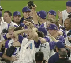  ?? Associated Press ?? The Diamondbac­ks celebrate after defeating the Yankees in Game 7 of the 2001 World Series.