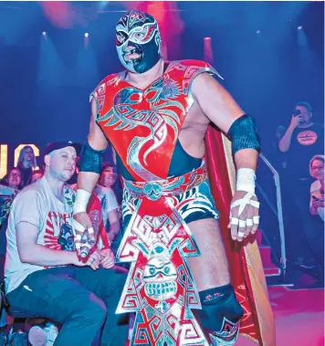  ??  ?? César González Barrón arrives for the bout, above, and executes a choke hold on Juventud Guerrera, left. Top left, González (gold mask) in a scene from the film Nacho Libre