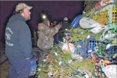  ?? KATHY JOHNSON ?? People look at the buoys on the Municipali­ty of Barrington’s lobster pot Christmas tree during the tree lighting celebratio­ns.