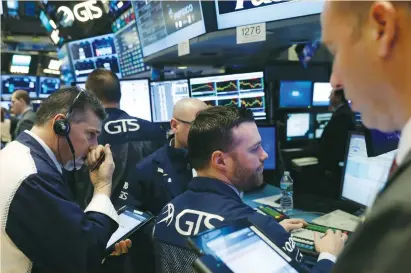  ?? (Lucas Jackson/Reuters) ?? TRADERS WORK on the floor of the New York Stock Exchange yesterday. Investors are awaiting a spate of Fed speakers this week, including chairwoman Janet Yellen on Thursday.