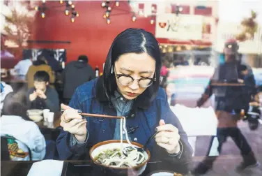  ?? Gabrielle Lurie / The Chronicle ?? Yiran Li eats at Kagawa-Ya Udon on Market Street, near Twitter in the Mid-Market neighborho­od.