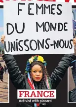  ??  ?? FRANCE Activist with placard