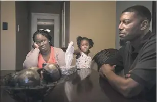  ??  ?? PARENTS Charmaine and Odell Edwards, at home in Mesquite, Texas, with daughter Korrie, recount the April day their son Jordan was killed by a police officer as he left a party.