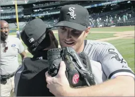  ?? Otto Greule Jr., Getty Images ?? White Sox pitcher Philip Humber is congratula­ted after throwing a perfect game against the Seattle Mariners at Seattle’s Safeco Field on Saturday afternoon.