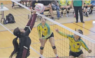  ?? PHOTOS BY JAMES BARRON THE NEW MEXICAN ?? TOP: SFIS middle hitter Erin Miles, right, blocks a hit from Pecos’ Kianna Quintana at the Santa Fe Indian School Pink Classic in Pueblo Pavilion. LEFT: Pecos outside hitter Desiree Sena returns the ball.